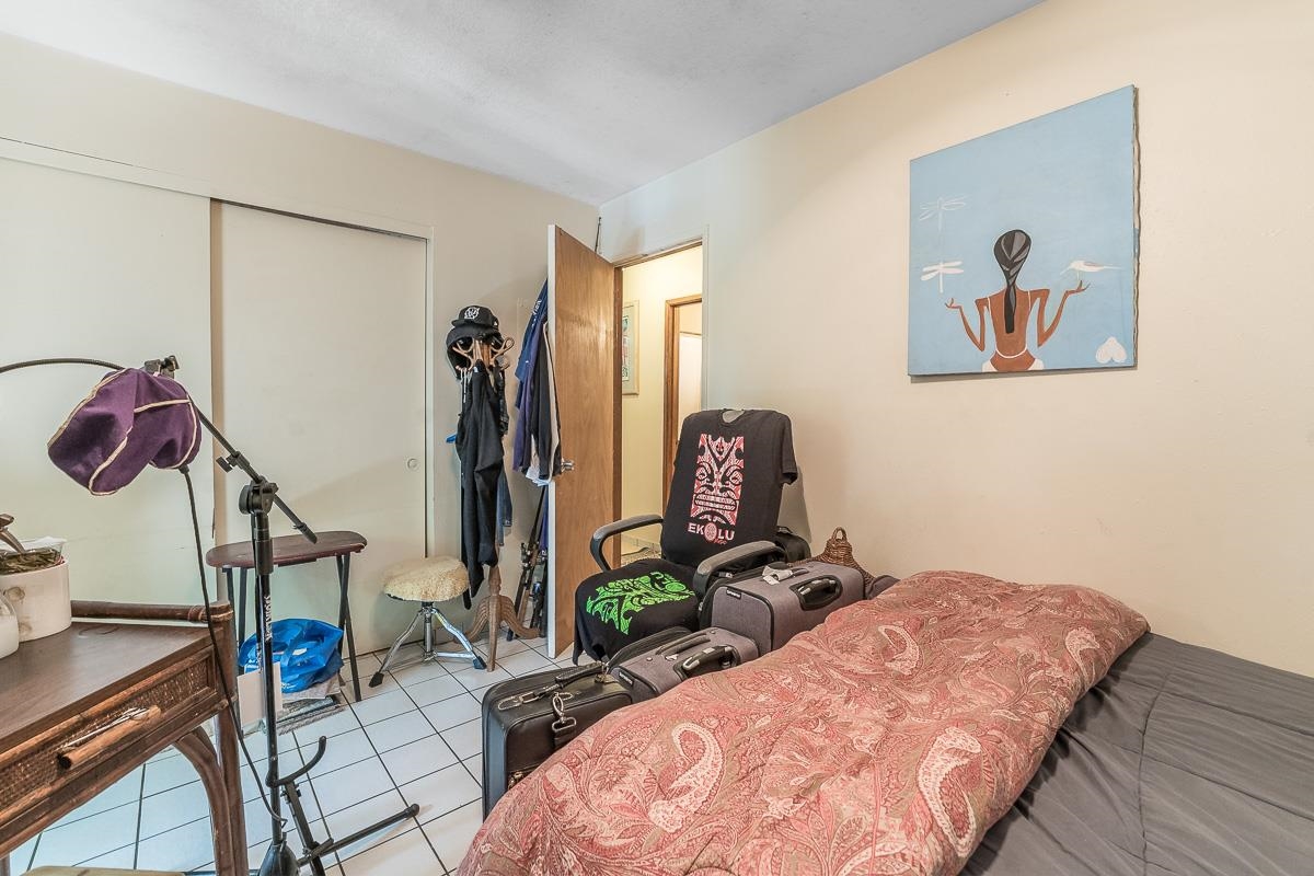 899 Kokomo Road Haiku, HI 96708 - Photo 17 of 26 a bed room with a bed and a window
