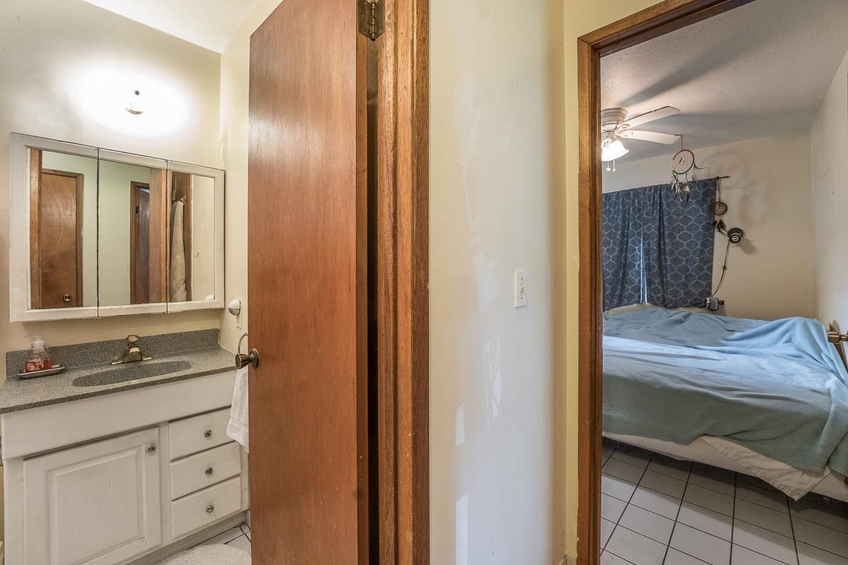 899 Kokomo Road Haiku, HI 96708 - Photo 18 of 26 a bathroom with a sink and a mirror