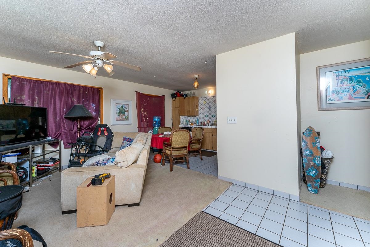 899 Kokomo Road Haiku, HI 96708 - Photo 2 of 26 a living room filled with furniture and a flat screen tv