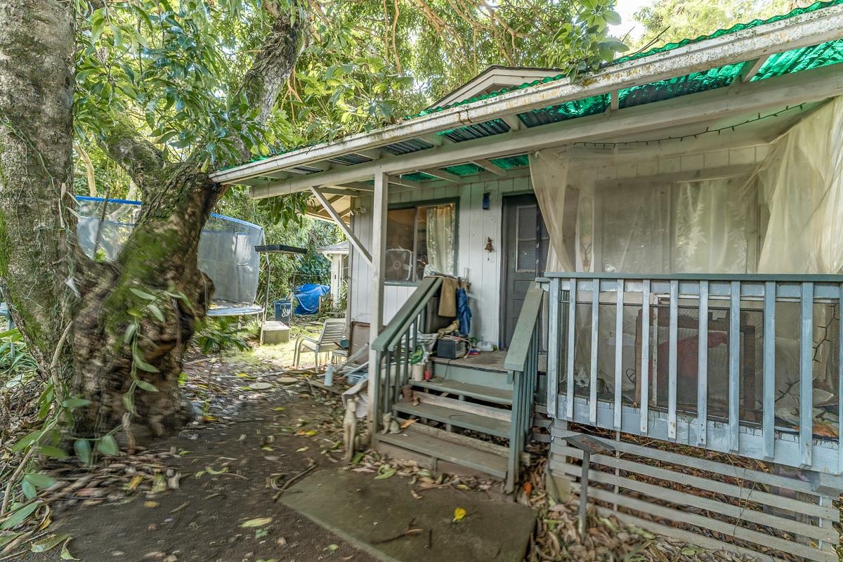 899 Kokomo Road Haiku, HI 96708 - Photo 26 of 26 a view of wooden house with a small yard