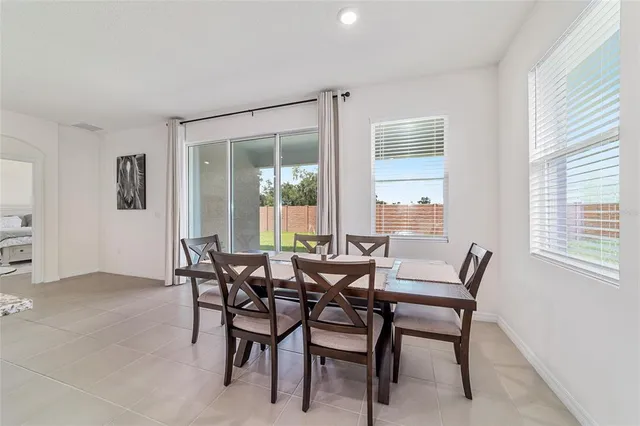 a kitchen with granite countertop a table and chairs in it
