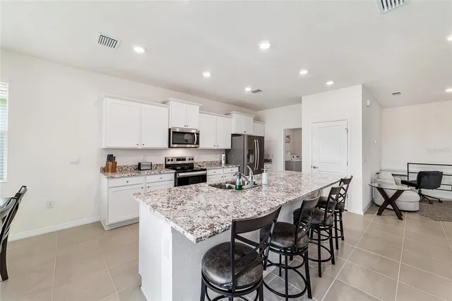 a kitchen with counter top space cabinets and stainless steel appliances