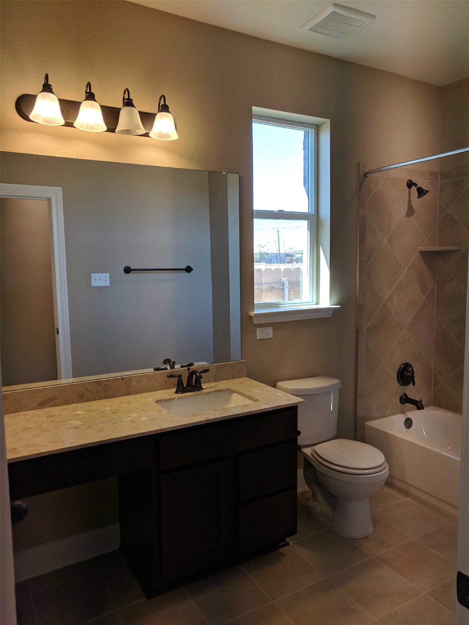 2471 Sunrise Road, Unit 8 Round Rock, TX 78664 - Photo 9 of 13 Bathroom featuring a dark wood-finish vanity with an integrated sink, a light-toned countertop, and a full-width mirror