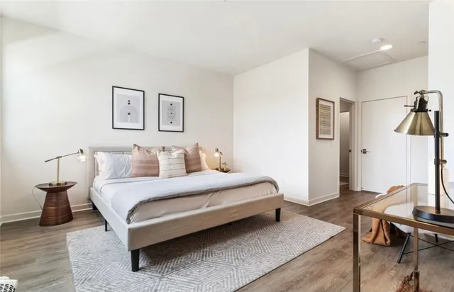 a bedroom with a bed and a table