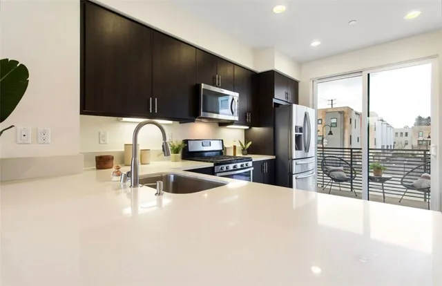 a kitchen with granite countertop a sink and a stove top oven