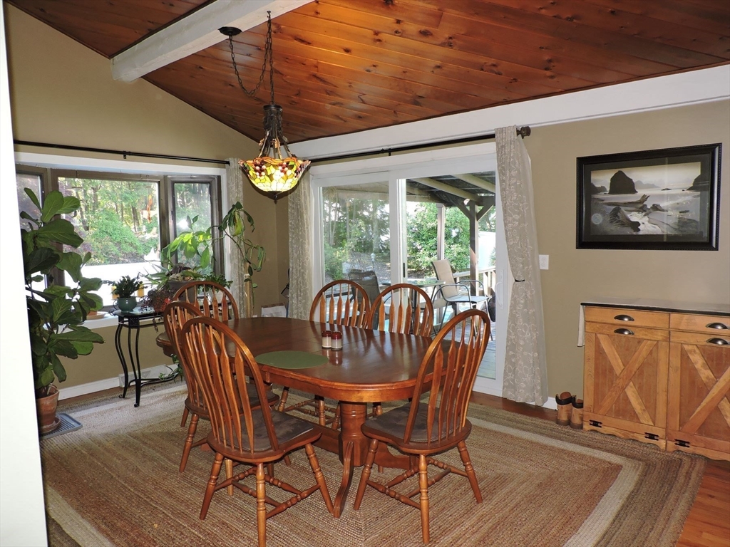 92 Lower Gore Road Webster, MA 01570 - Photo 15 of 42 a dining room with furniture a chandelier and wooden floor