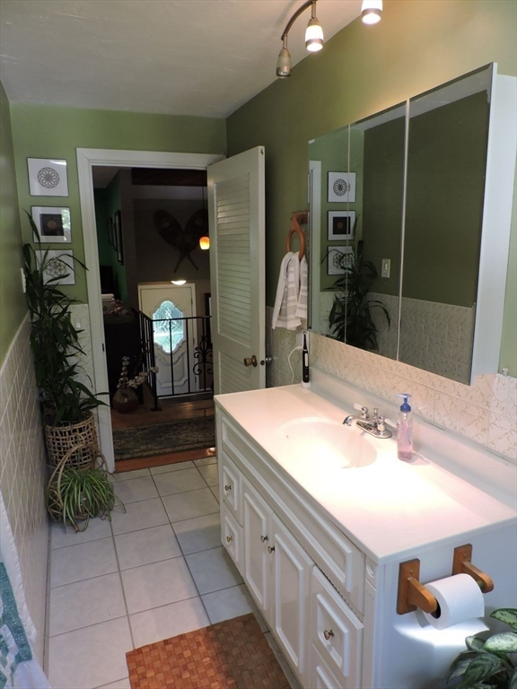 92 Lower Gore Road Webster, MA 01570 - Photo 22 of 42 a bathroom with a double vanity sink and a mirror