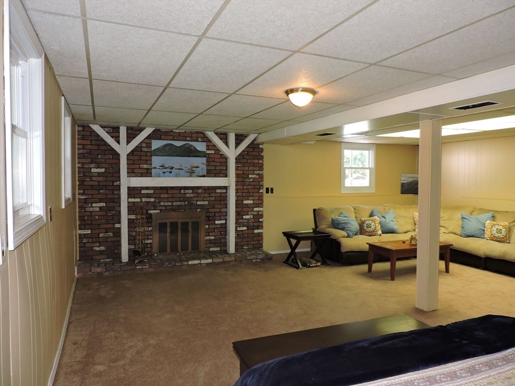 92 Lower Gore Road Webster, MA 01570 - Photo 30 of 42 a living room with furniture a fireplace and a table