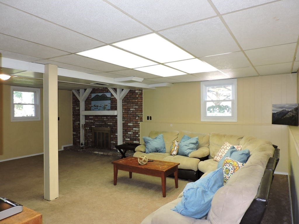 92 Lower Gore Road Webster, MA 01570 - Photo 32 of 42 a living room with furniture and a fireplace