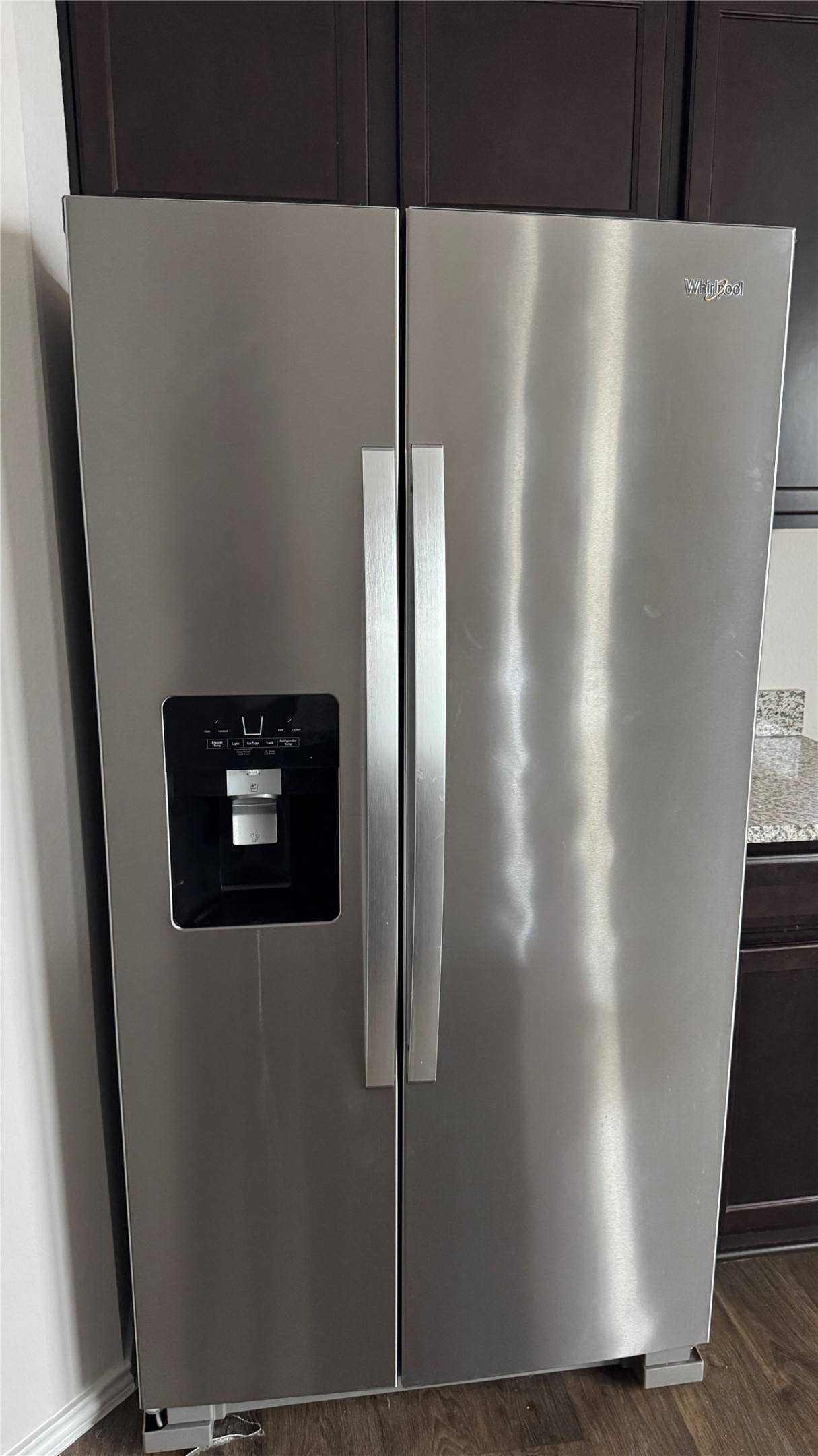 408 Frogmore Loop Kyle, TX 78640 - Photo 29 of 32 A well-maintained side-by-side refrigerator, providing ample cold storage with a convenient water and ice dispenser.