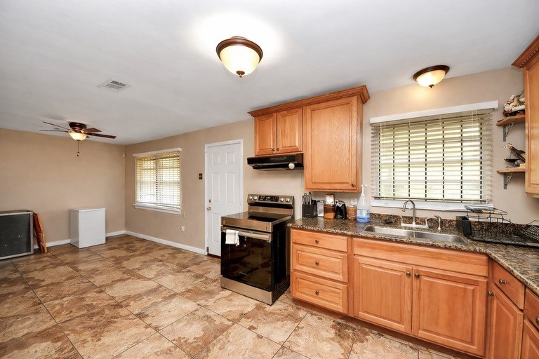 2914 Dragonwick Drive Houston, TX 77045 - Photo 11 of 37 a kitchen with stainless steel appliances granite countertop a stove a sink and a refrigerator