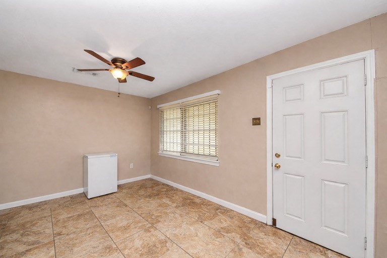 2914 Dragonwick Drive Houston, TX 77045 - Photo 16 of 37 an empty room with a window and a ceiling fan