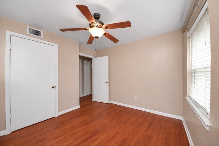 2914 Dragonwick Drive Houston, TX 77045 - Photo 20 of 37 a view of an empty room with wooden floor and window