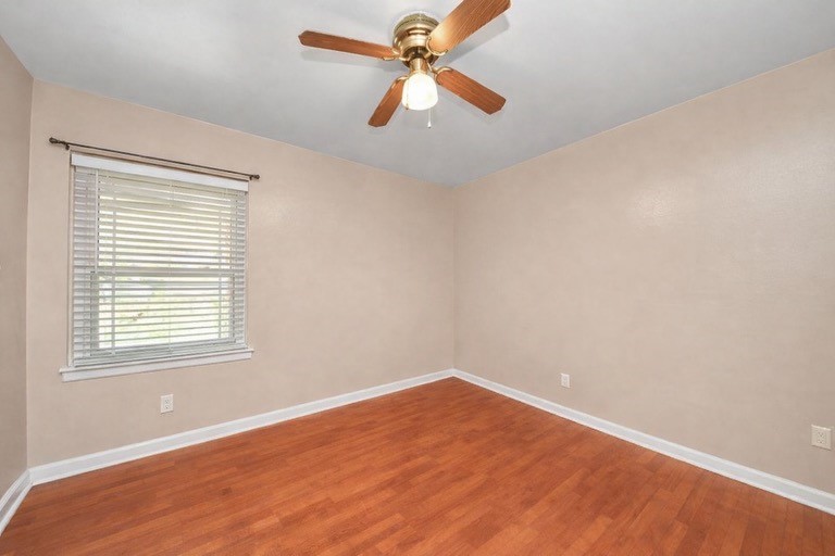 2914 Dragonwick Drive Houston, TX 77045 - Photo 24 of 37 an empty room with a window and a fan