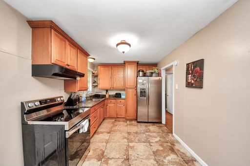 2914 Dragonwick Drive Houston, TX 77045 - Photo 4 of 37 a kitchen with stainless steel appliances a stove a refrigerator and cabinets