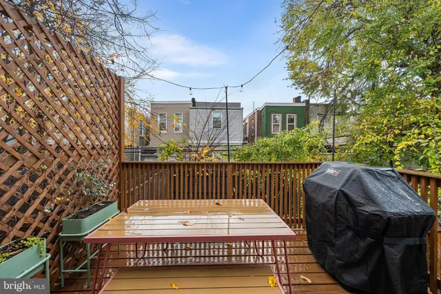 a view of a roof deck with wooden floor and fence