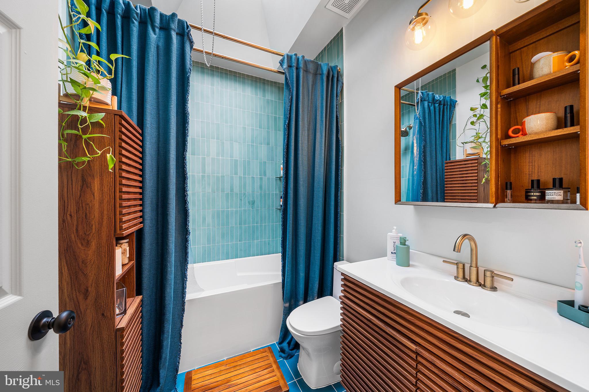 5426 Irving Street Philadelphia, PA 19139 - Photo 19 of 28 a bathroom with a sink a toilet and shower