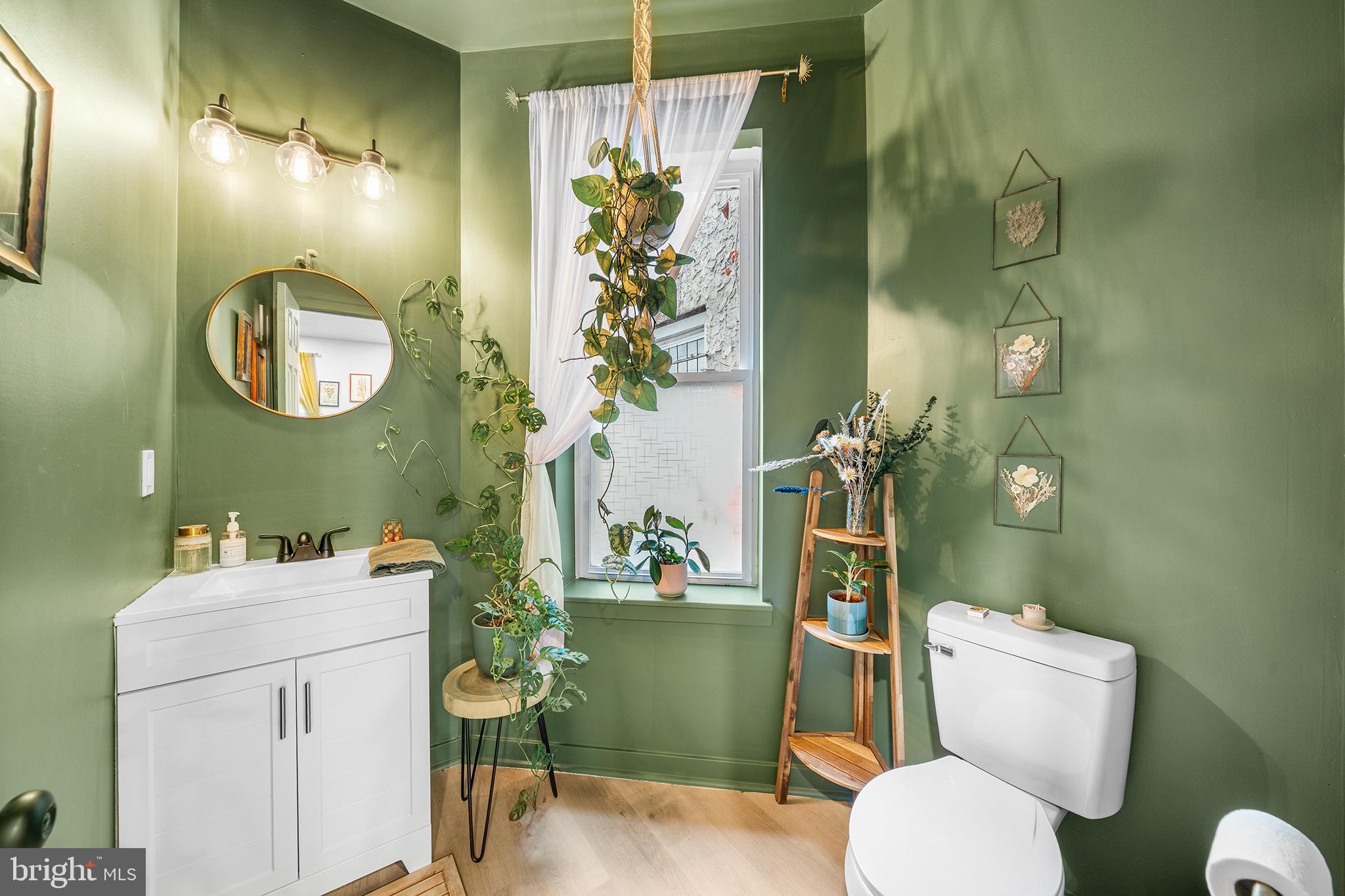 5426 Irving Street Philadelphia, PA 19139 - Photo 6 of 28 a bathroom with a toilet sink and mirror