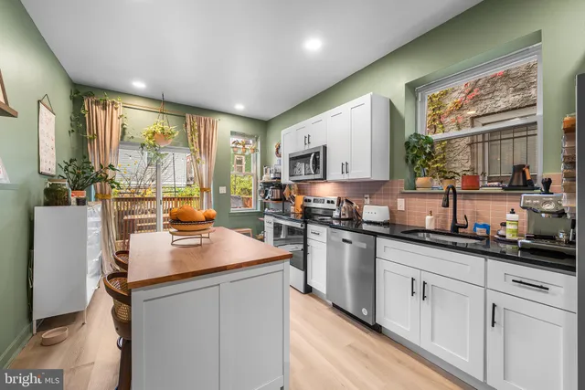 a kitchen with sink cabinets and window