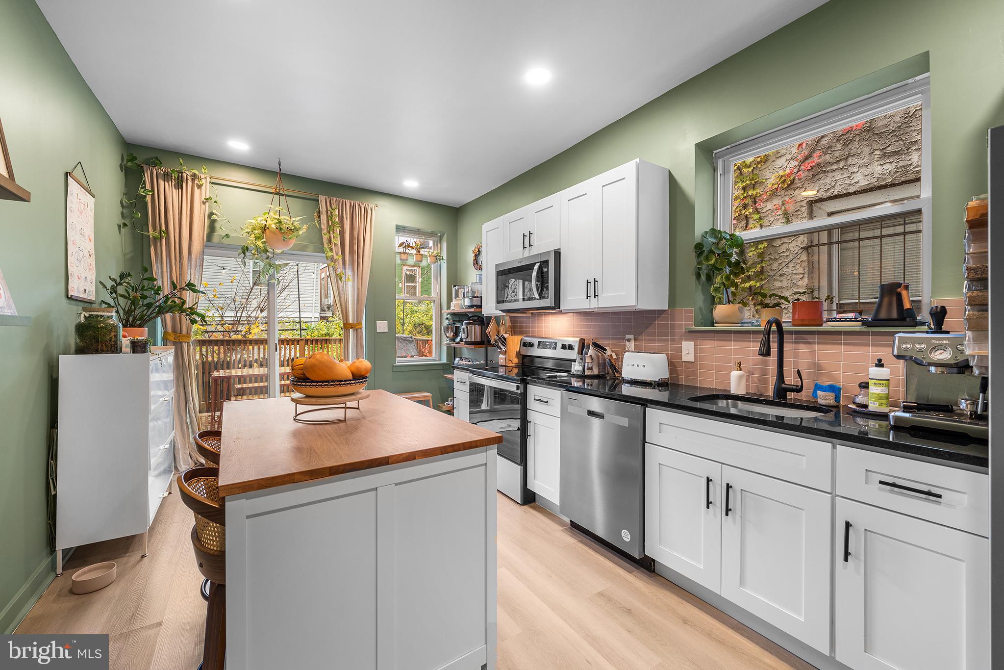 5426 Irving Street Philadelphia, PA 19139 - Photo 7 of 28 a kitchen with sink cabinets and window