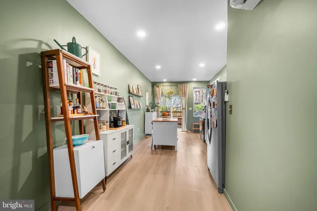 a view of a hallway with wooden floor and entryway