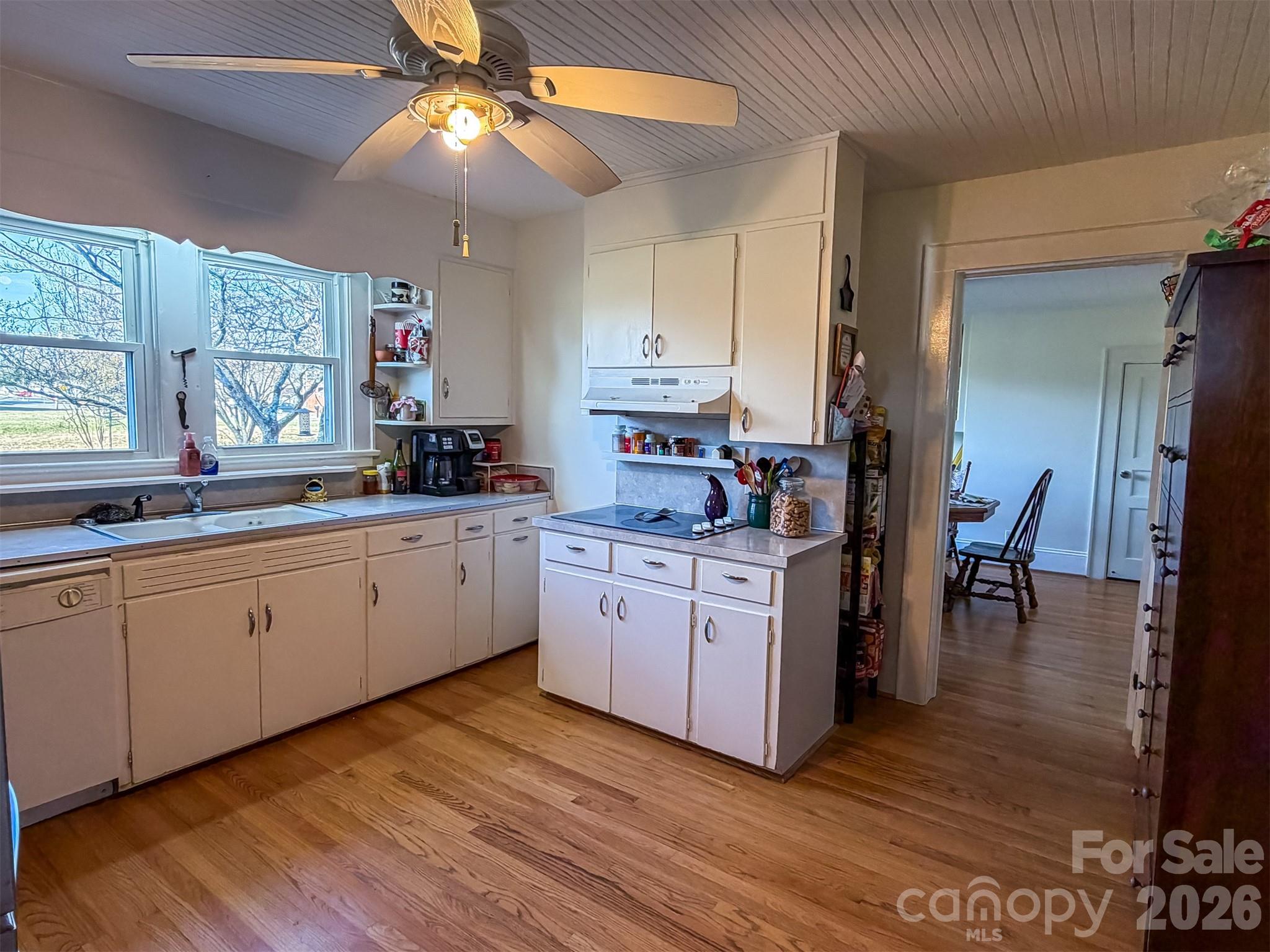4363 Section House Road Hickory, NC 28601 - Photo 16 of 48 a kitchen with a dining table chairs sink and cabinets