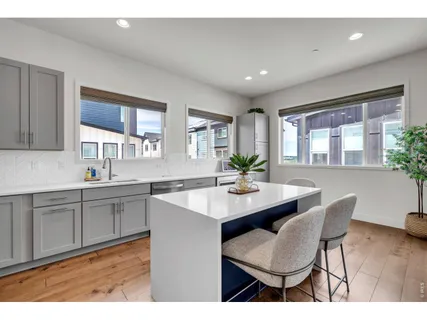 a kitchen with a sink and chairs