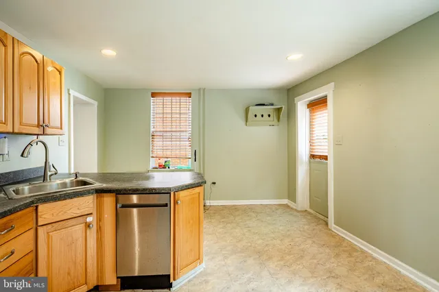 a kitchen with stainless steel appliances granite countertop a sink and a cabinets