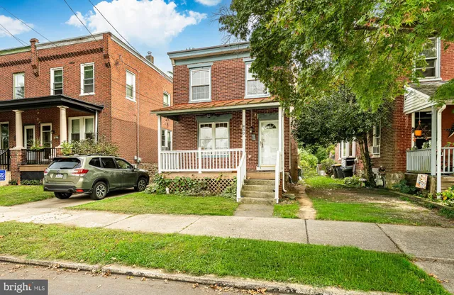 a car parked in front of a brick house