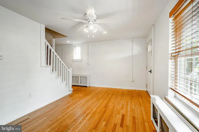 a view of a room with wooden floor and staircase
