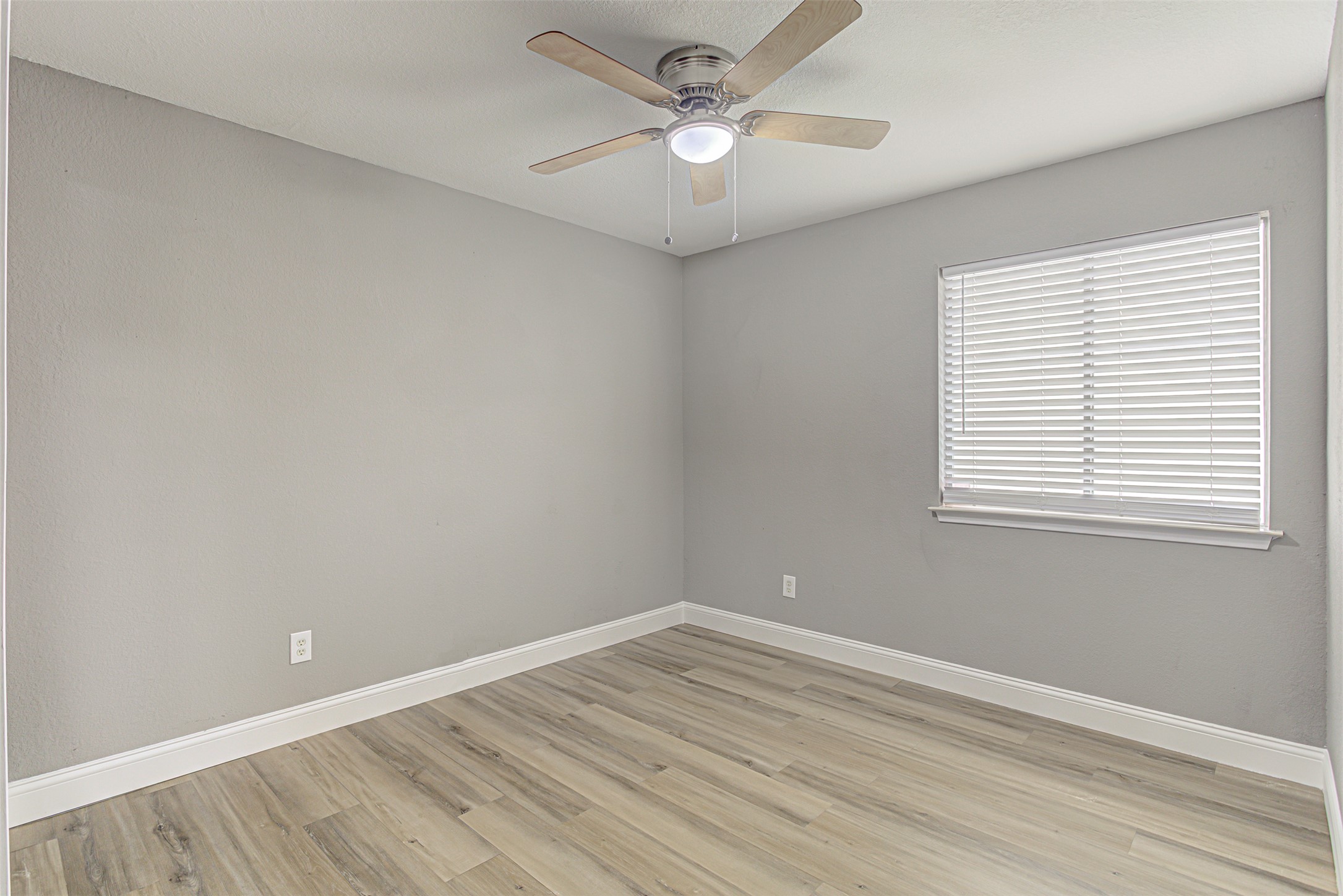 17838 Loch Linnhe Loop Pflugerville, TX 78660 - Photo 22 of 35 wooden floor in an empty room with a window