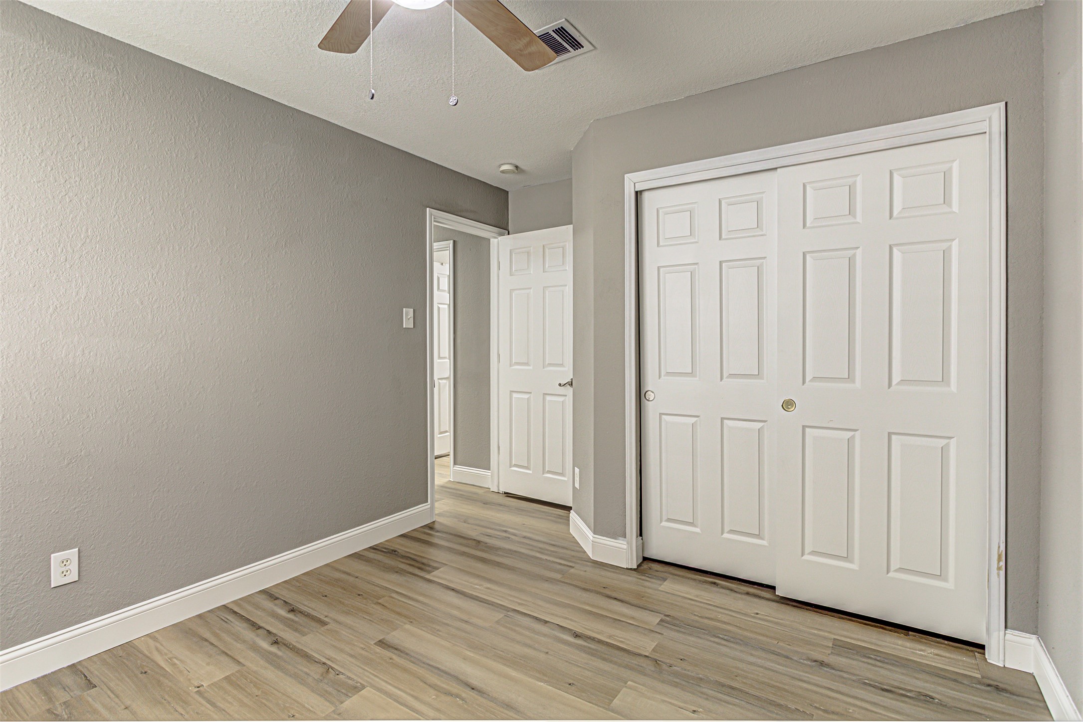 17838 Loch Linnhe Loop Pflugerville, TX 78660 - Photo 23 of 35 an empty room with wooden floor and closet area