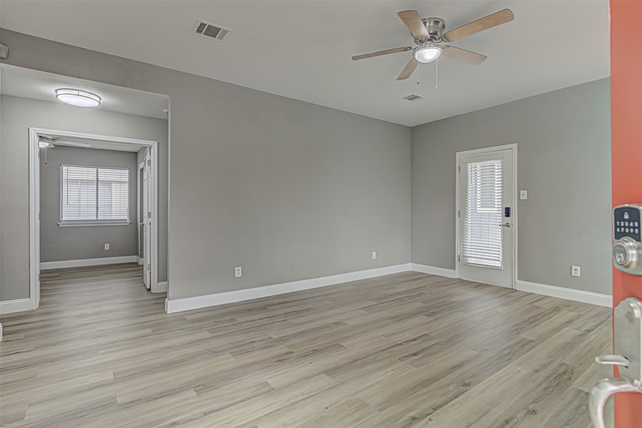 17838 Loch Linnhe Loop Pflugerville, TX 78660 - Photo 4 of 35 wooden floor in an empty room with a window