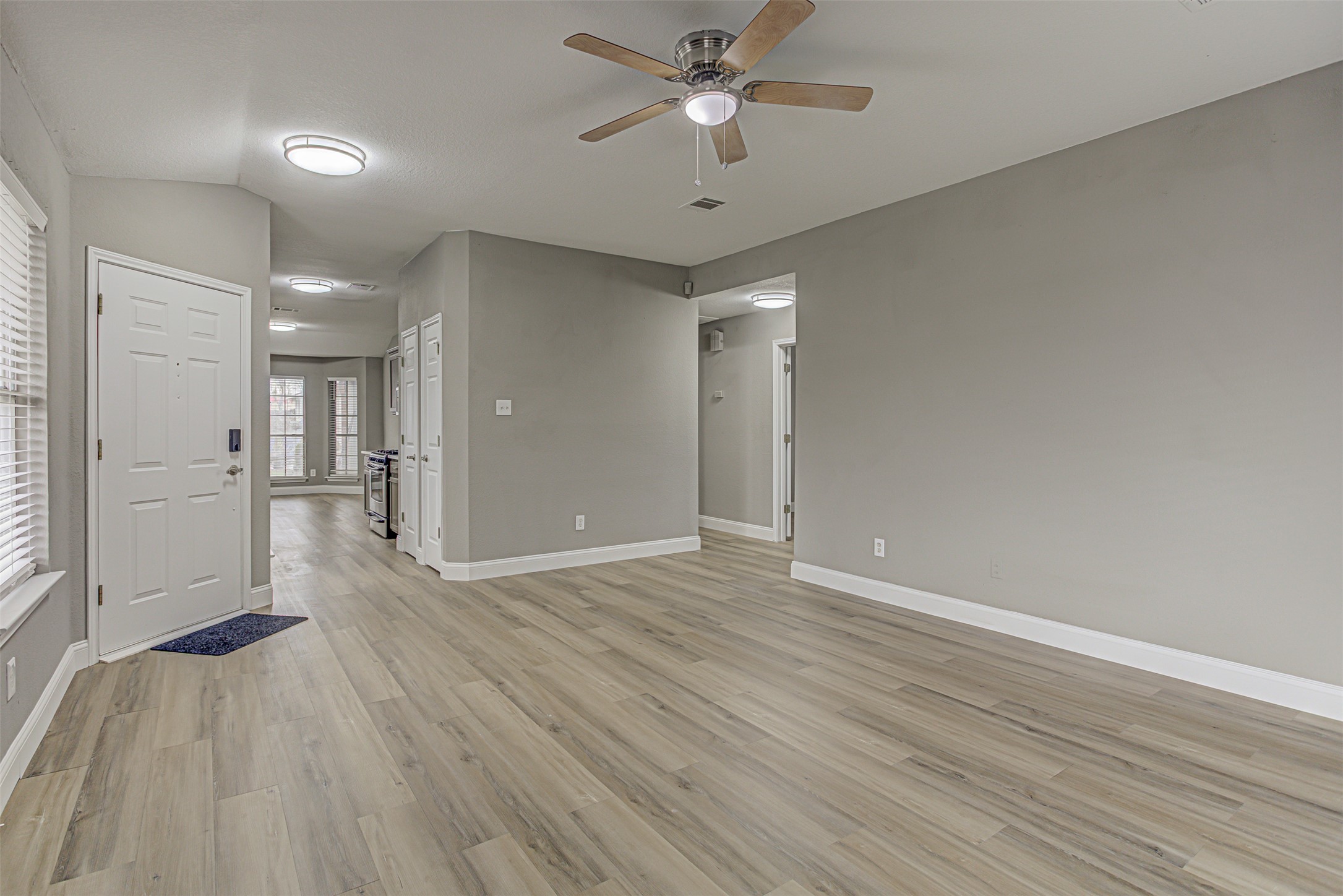 17838 Loch Linnhe Loop Pflugerville, TX 78660 - Photo 5 of 35 wooden floor in an empty room with a window