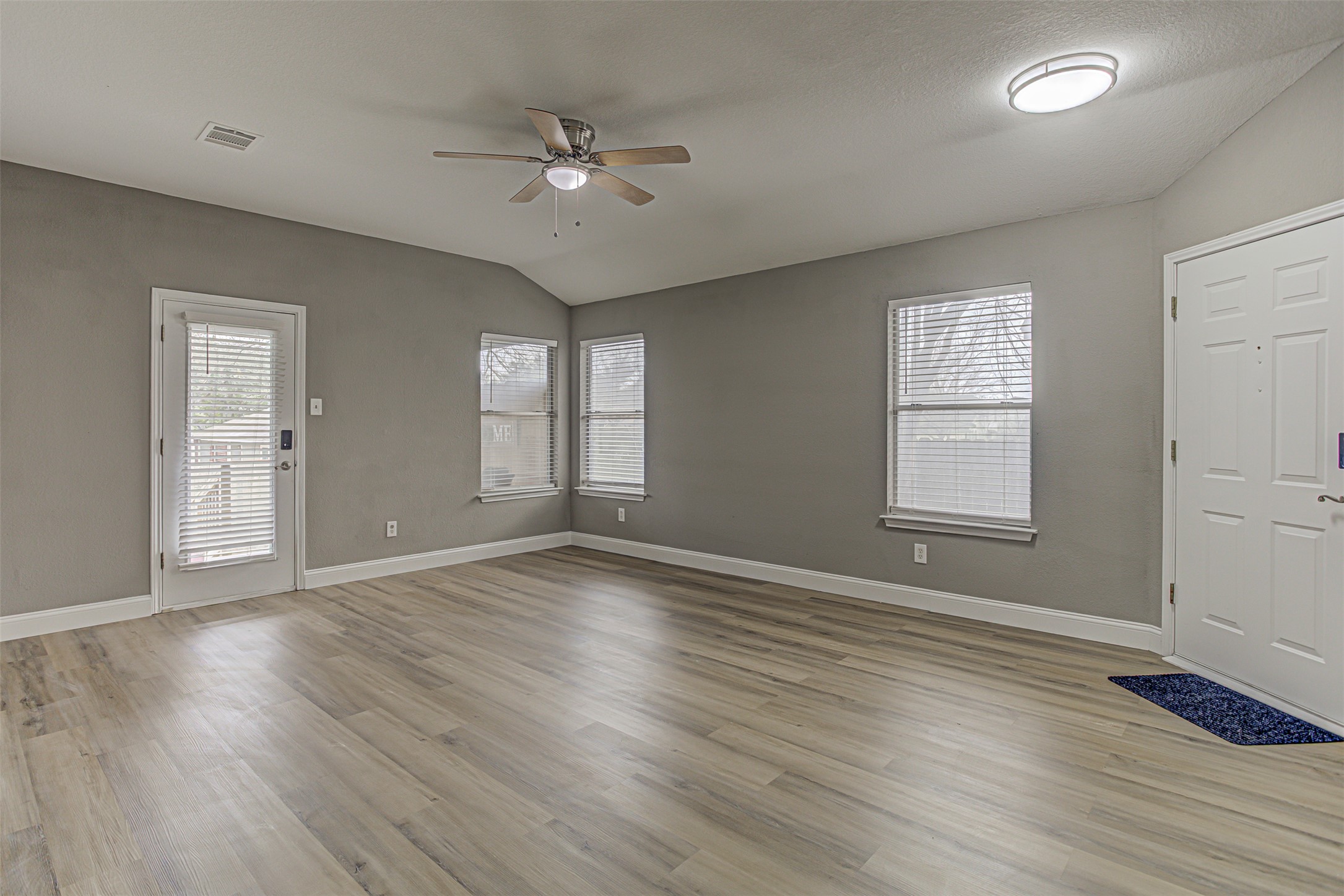 17838 Loch Linnhe Loop Pflugerville, TX 78660 - Photo 6 of 35 a view of an empty room with wooden floor and a window