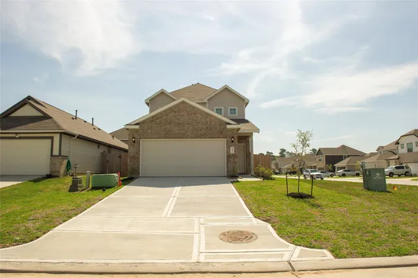 a view of a white house with a yard and table and chairs
