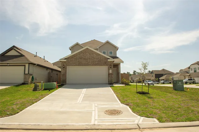 a view of a white house with a yard and table and chairs