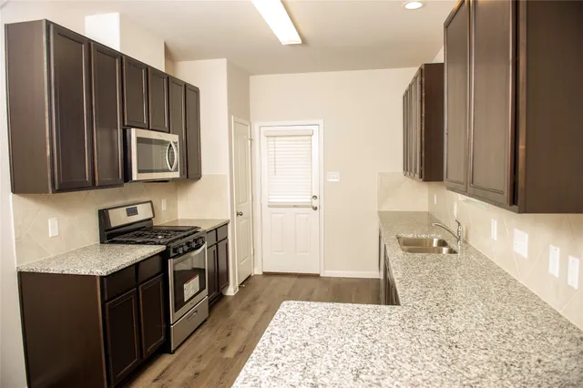 a kitchen with a stove a sink and a microwave
