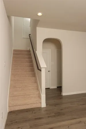 a view of entryway and hall with wooden floor