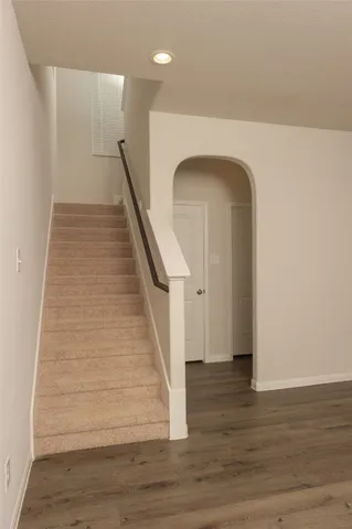 a view of entryway and hall with wooden floor