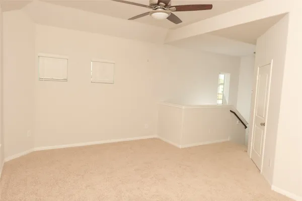 a view of a room with a ceiling fan