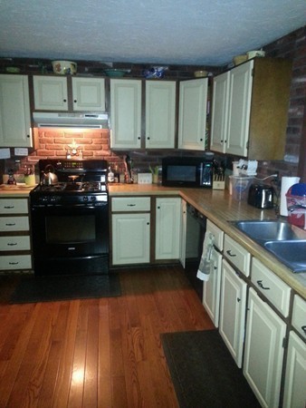 45 Sassawanna Road Rutland, MA 01543 - Photo 8 of 27 a kitchen with stainless steel appliances a stove sink and cabinets