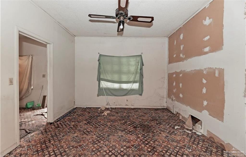 107 East Main Street Rio Grande City, TX 78582 - Photo 11 of 16 Spare room featuring a ceiling fan and a textured ceiling