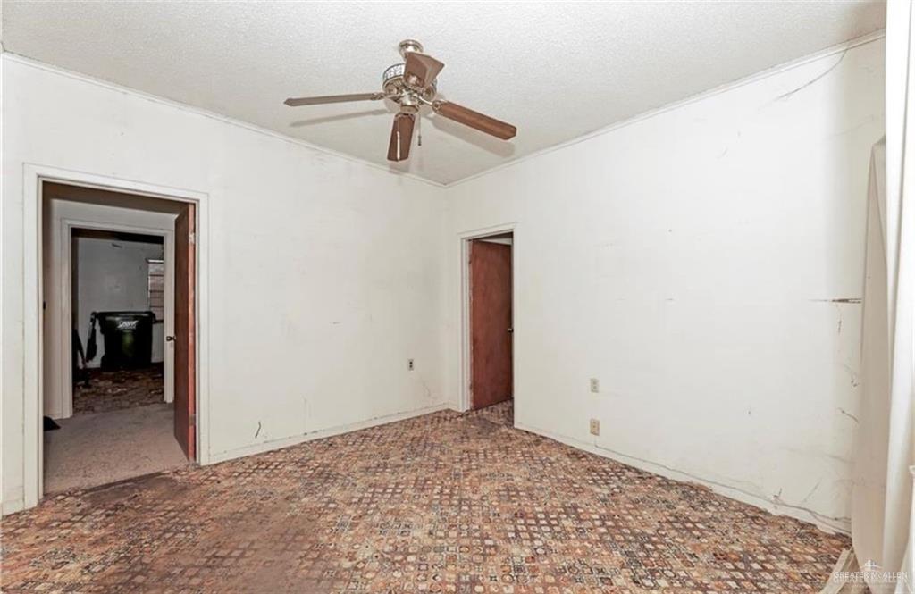 107 East Main Street Rio Grande City, TX 78582 - Photo 14 of 16 Unfurnished bedroom featuring a textured ceiling and ceiling fan
