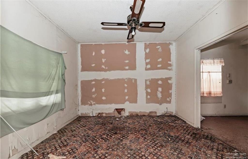 107 East Main Street Rio Grande City, TX 78582 - Photo 7 of 16 Carpeted spare room featuring a ceiling fan