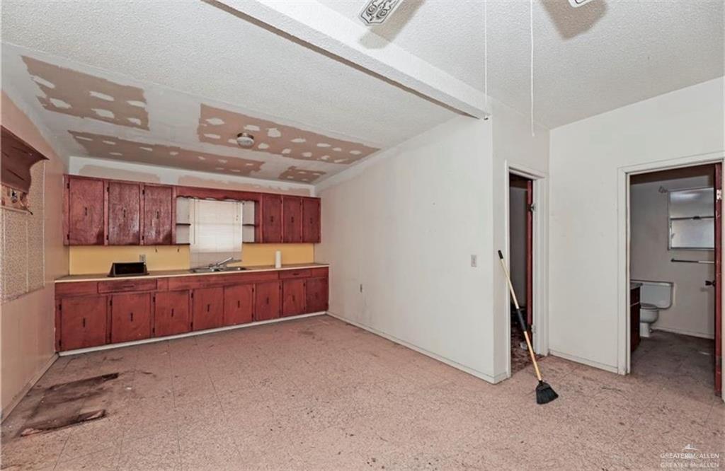 107 East Main Street Rio Grande City, TX 78582 - Photo 10 of 16 Kitchen with a sink and brown cabinetry