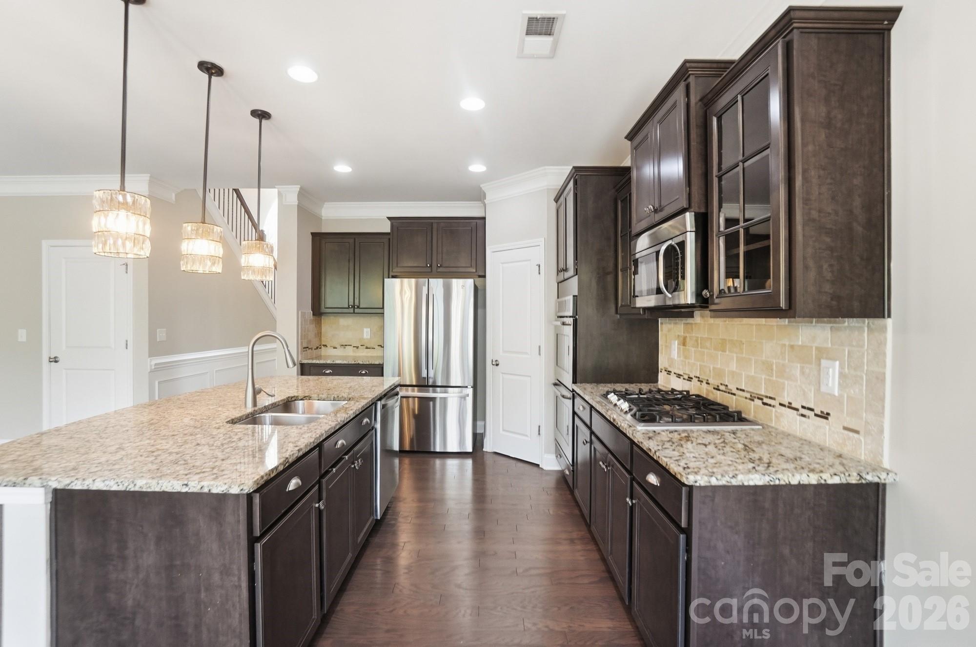 9407 Inverness Bay Road Charlotte, NC 28278 - Photo 25 of 29 a kitchen with granite countertop a sink a counter top space stove and refrigerator