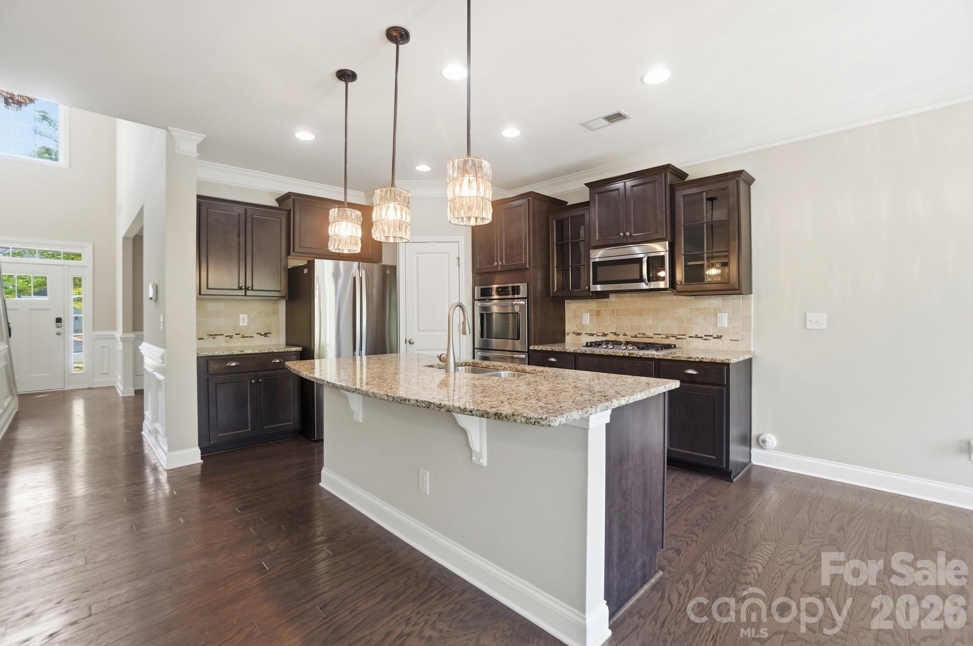 9407 Inverness Bay Road Charlotte, NC 28278 - Photo 26 of 29 a kitchen with stainless steel appliances kitchen island granite countertop a refrigerator a stove and a sink