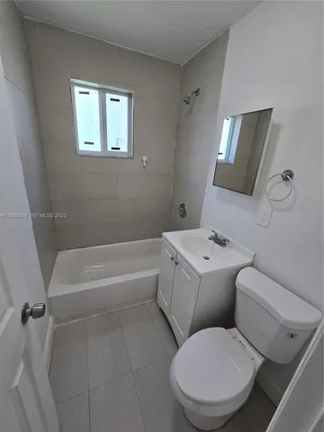 a bathroom with a toilet a sink and bathtub