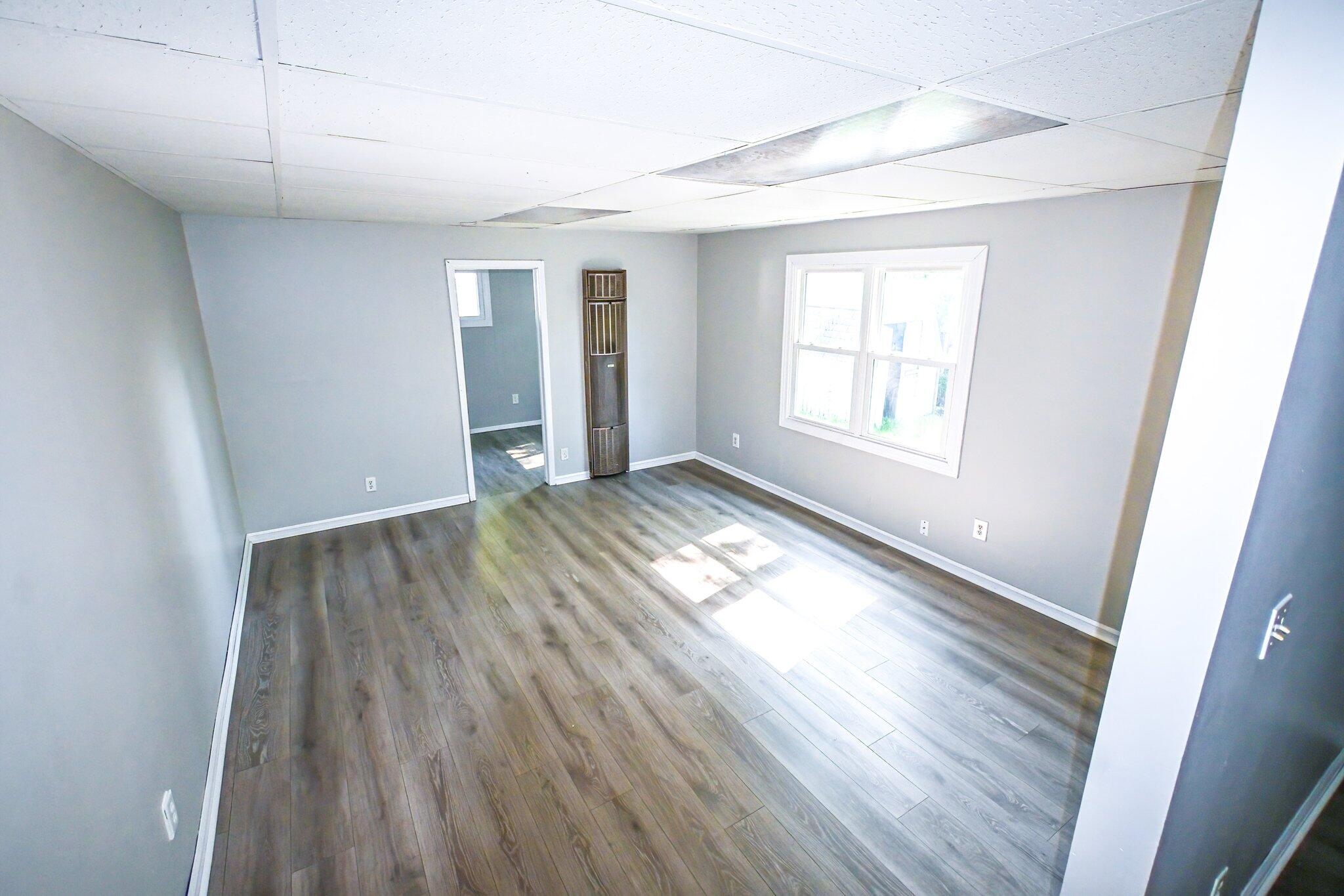 7828 Chestnut Avenue Hammond, IN 46324 - Photo 16 of 23 an empty room with wooden floor and windows